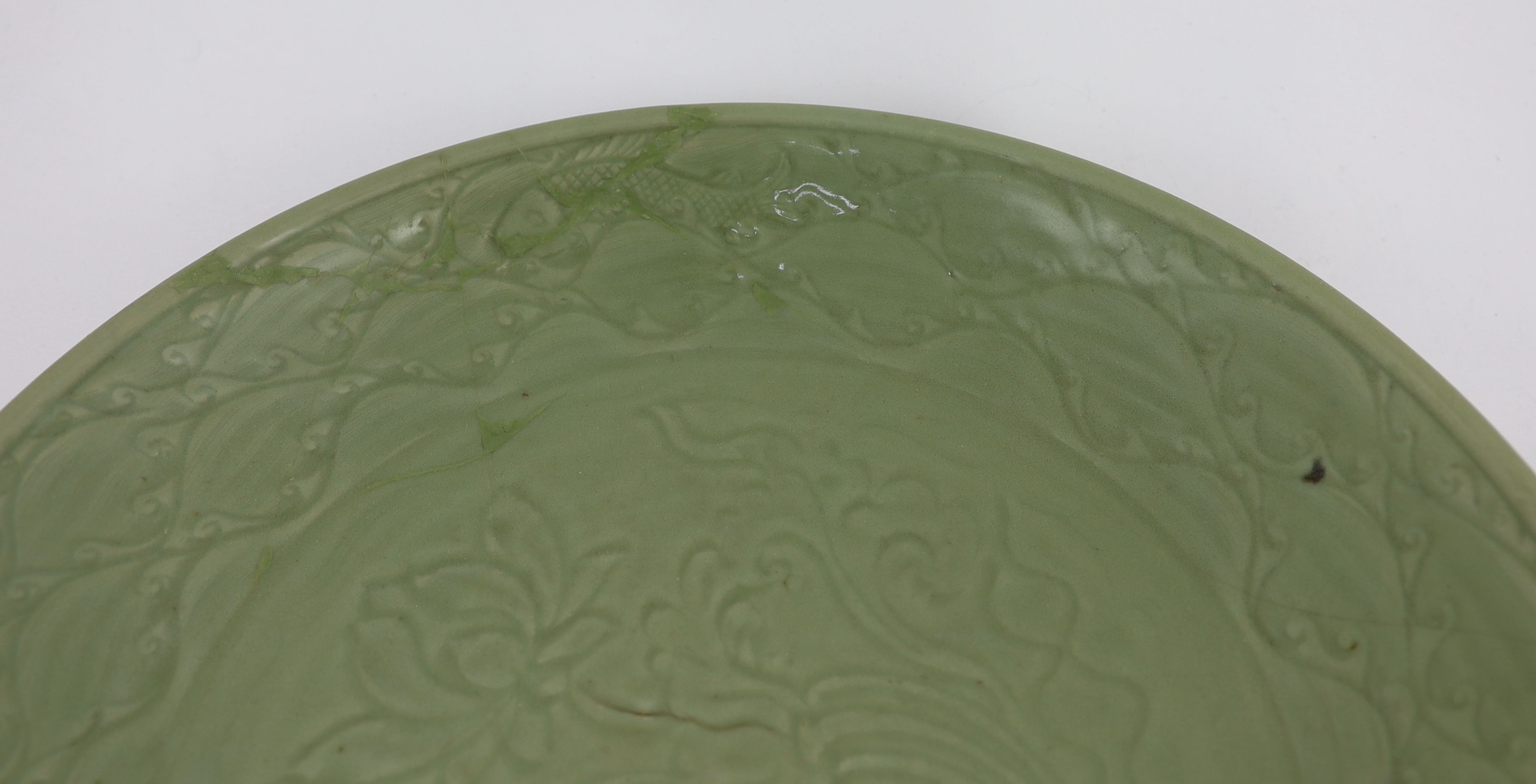 A rare large Chinese Ming Longquan celadon dish, 14th century, 44 cm diameter, Broken and restored